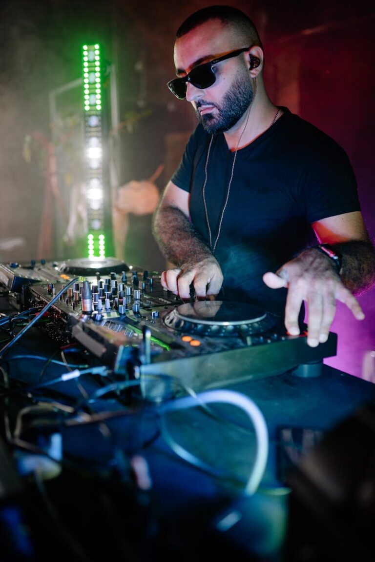 DJ spinning tracks at a lively nightclub event with vibrant lighting and energetic atmosphere.